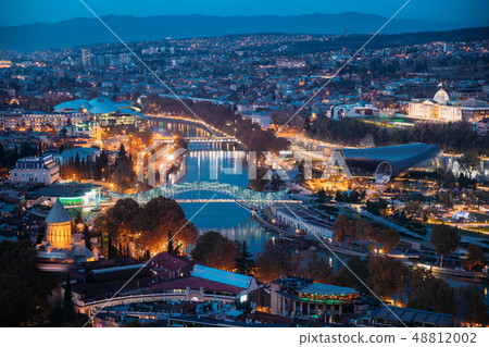 Tbilisi, Georgia. Aerial View Of Justice House, Bridge Of Peace, Concert Hall In Evening Or Night Tbilisi, Georgia. Aerial View Of Justice House, Bridge Of Peace, Concert Hall In Evening Or Night 48812002