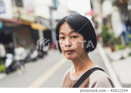 Asian woman walking on the street Asian woman walking on the street 48812294