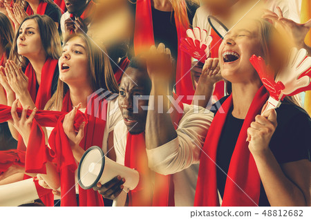 Group of happy fans are cheering for their team victory. Group of happy fans are cheering for their team victory. 48812682