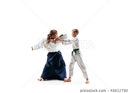 Man and teen boy fighting at aikido training in martial arts school Man and teen boy fighting at aikido training in martial arts school 48812780