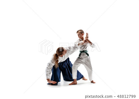 Man and teen boy fighting at aikido training in martial arts school Man and teen boy fighting at aikido training in martial arts school 48812799