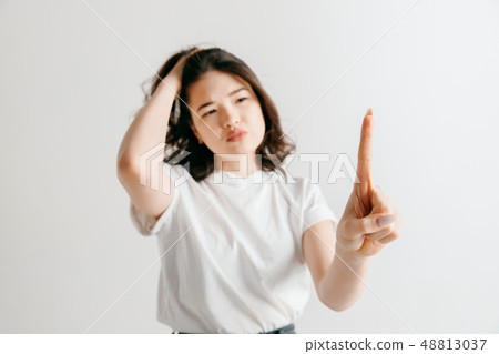 Woman's hand with finger on gray background Woman's hand with finger on gray background 48813037