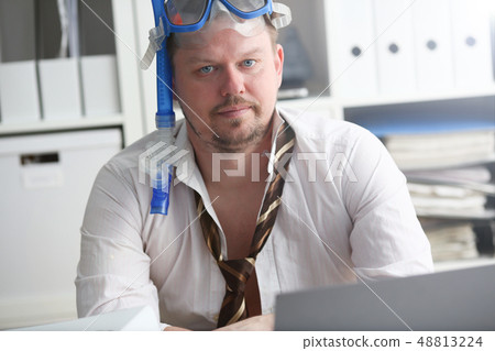 Man wearing suit and tie in goggles with snorkel 48813224