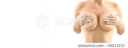 Female hand in gloves holding breast closeup 48813231