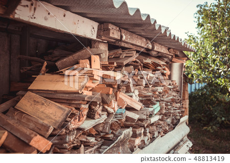 Stack of firewood under the roof near the house Stack of firewood under the roof near the house 48813419