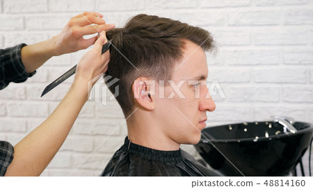 Female hairdresser haircut doing male hair style 48814160