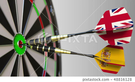 Flags of the United Kingdom and Spain on darts hitting bullseye of the target. International Flags of the United Kingdom and Spain on darts hitting bullseye of the target. International 48816128