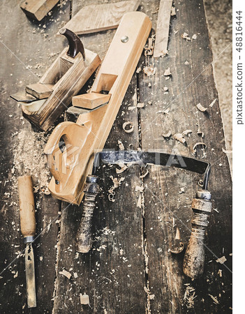 Old woodworking hand tool: wooden plane, chisel and drawing knife in a carpentry workshop on dirty 48816444
