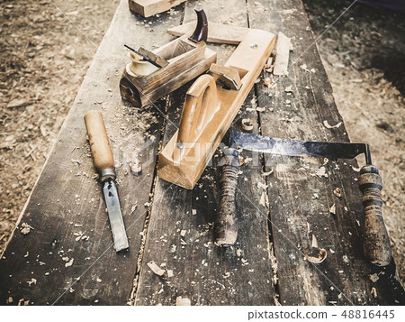 Old woodworking hand tool: wooden plane, chisel and drawing knife in a carpentry workshop on dirty 48816445