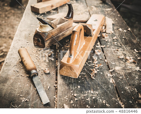 Old woodworking hand tool: wooden plane, chisel and drawing knife in a carpentry workshop on dirty 48816446