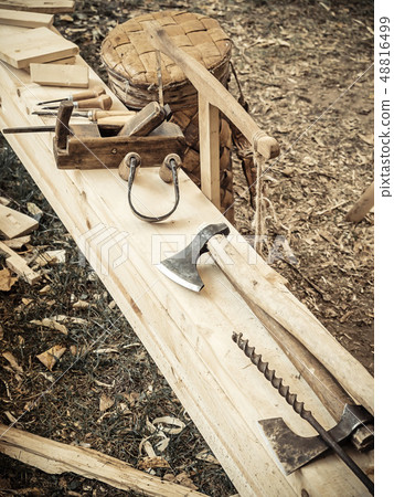 Old woodworking hand tool: wooden plane, chisel ax, and drawing knife in a carpentry workshop on 48816499