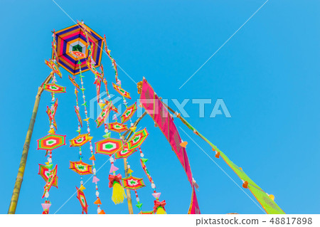 wind blowing colorful flags with the blue sky bac 48817898