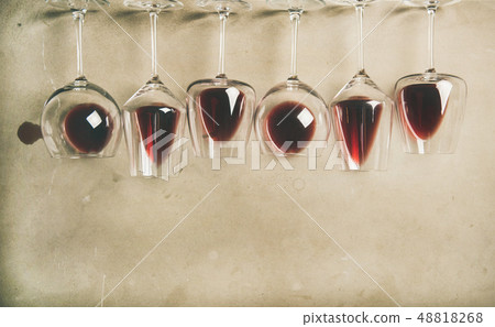 Red wine in different glasses over grey 48818268