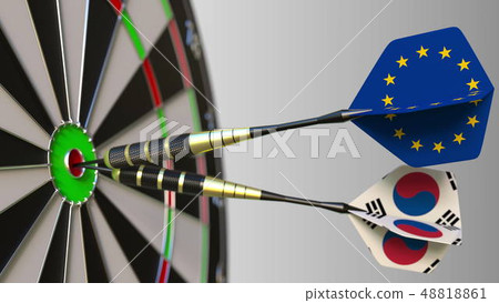 Flags of the European Union and Korea on darts hitting bullseye of the target. International 48818861