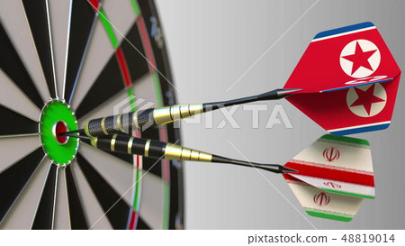 Flags of North Korea and Iran on darts hitting bullseye of the target. International cooperation or Flags of North Korea and Iran on darts hitting bullseye of the target. International cooperation or 48819014