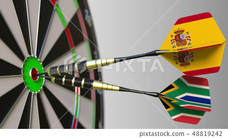 Flags of Spain and South Africa on darts hitting bullseye of the target. International cooperation 48819242