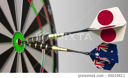 Flags of Japan and Australia on darts hitting bullseye of the target. International cooperation or Flags of Japan and Australia on darts hitting bullseye of the target. International cooperation or 48819811