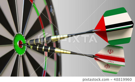 Flags of the UAE and Iran on darts hitting bullseye of the target. International cooperation or 48819960