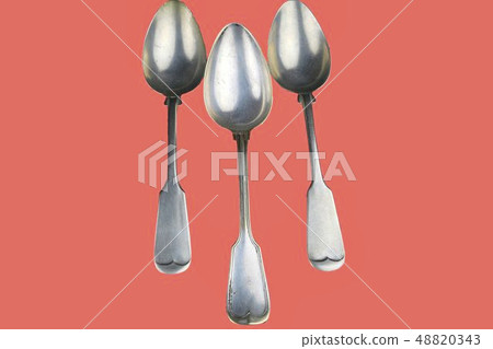 Old spoons on a living coral background. Color of the year 2019 living coral. Top view. Free space 48820343