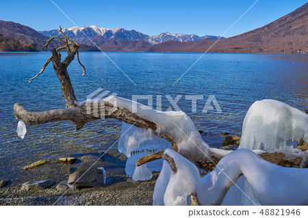 Mountains and splashed ice from the south shore of Lake Chuoji Temple in Nikko towards the northwest of the remaining snow 48821946