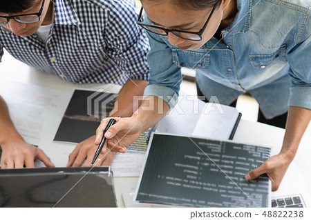 Programmer working in a software development and Programmer working in a software development and 48822238