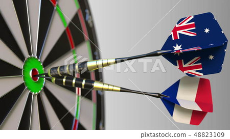 Flags of Australia and France on darts hitting bullseye of the target. International cooperation or 48823109