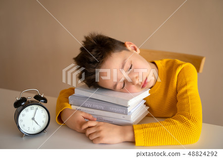 Little boy sleeping over books. Tired schoolboy studying in home. Little boy sleeping over books. Tired schoolboy studying in home. 48824292