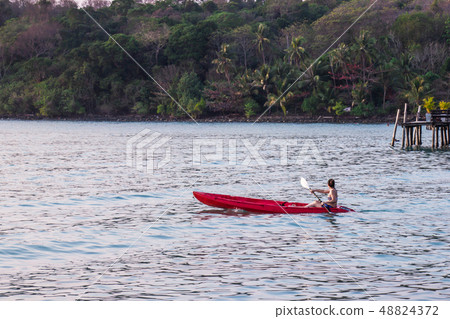 Women tourists wear bikini set kayaking in sea. Women tourists wear bikini set kayaking in sea. 48824372