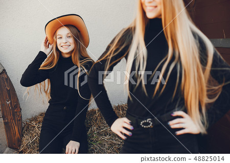 Girls in a cowboys hat on a ranch Girls in a cowboys hat on a ranch 48825014