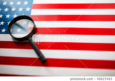 The American flag is viewed through a magnifying 48825483