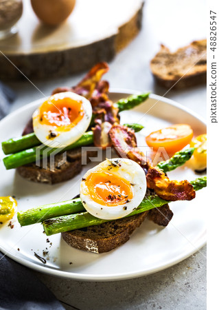 Bacon ,Seared Aspargus and Soft boiled egg on Rye Bacon ,Seared Aspargus and Soft boiled egg on Rye 48826547