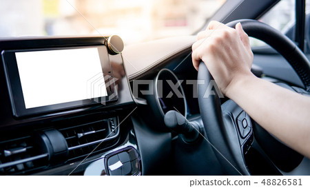Driver hand holding steering wheel in the car 48826581