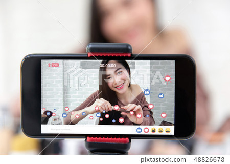 Asian woman beauty vlogger sharing makeup tutorial 48826678