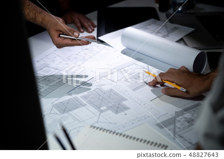 Architect team discussing blueprint paper in Architect team discussing blueprint paper in 48827643