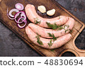 Cooking raw sausages 48830694