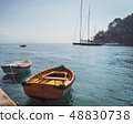 Two wooden fishing boats moored in small marina 48830738