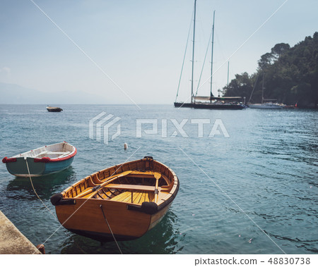 Two wooden fishing boats moored in small marina 48830738