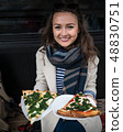 Happy young woman holds two big pieces of pizza 48830751