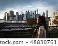 Young woman standing on riverside in Brooklyn 48830761