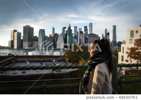 Young woman standing on riverside in Brooklyn 48830761