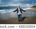 Young man standing on the beach 48830804