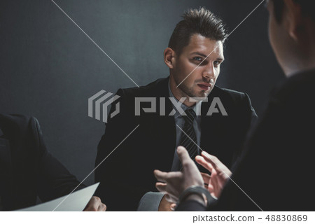 Detectives in interrogation room with suspect or 48830869