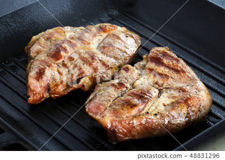 Two Grilled beef steaks on grill pan. 48831296