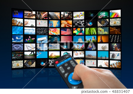 TV screen with lot of pictures and hands of man with remote control on blue background 48831407