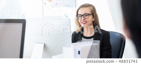 Smiling businesswoman working on computer in Smiling businesswoman working on computer in 48831741