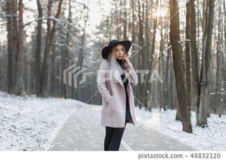 Young beautiful girl in a stylish hat and coat Young beautiful girl in a stylish hat and coat 48832120