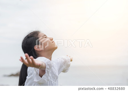 Carefree young girl taking deep breath relaxing Carefree young girl taking deep breath relaxing 48832680