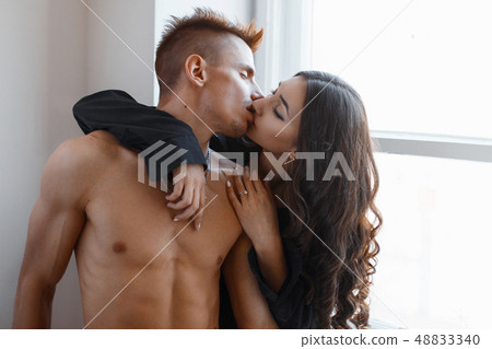 Close-up portrait of a young couple kissing 48833340