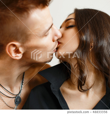 Close-up portrait of a young couple kissing Close-up portrait of a young couple kissing 48833356