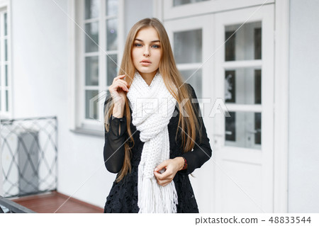 Stylish young beautiful girl in a black dress Stylish young beautiful girl in a black dress 48833544